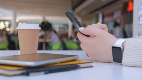 Female hands using modern smartphone . Young girl sitting at bench in shopping Stock Footage 240854867