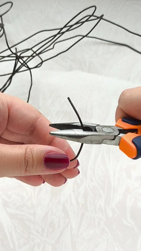 Female hands using pliers cut metal wire. Repair. Video stock 314307236