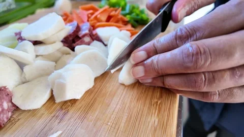 Female hands using a sharp knife for cutting fresh radish Stock Footage 329343214