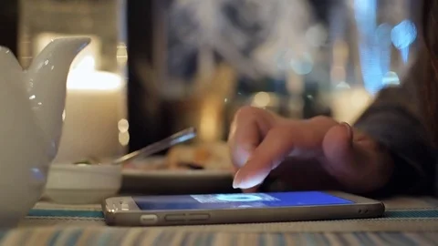 Female hands using smart phone in city cafe. Stock Footage 84647267