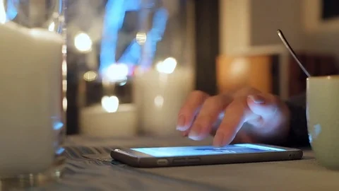 Female hands using smart phone in city cafe. 動画素材 84674795