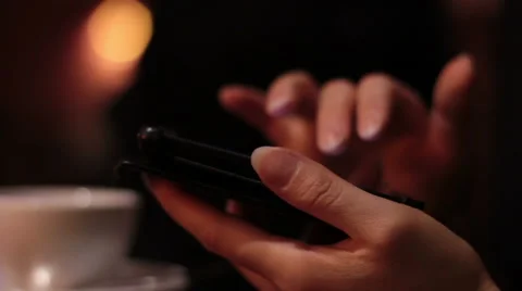 Female hands using a smartphone in the cafe and the waitress brings the order Stock Footage 65297915