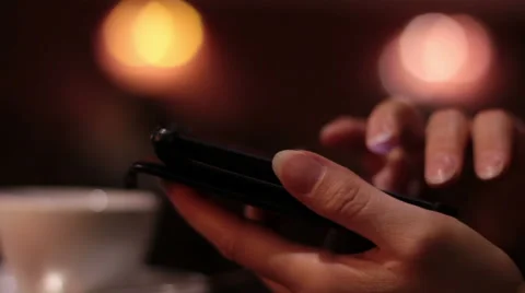 Female hands using a smartphone in cafe Stock Footage 65297919