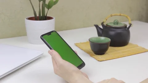 Female hands using a smartphone with green screen Stock Footage 127837633