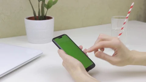 Female hands using a smartphone with green screen Stock Footage 127837713