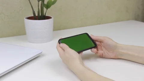 Female hands using a smartphone with green screen Stock Footage 127837876