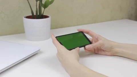 Female hands using a smartphone with green screen Stock Footage 127837923