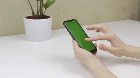 Female hands using a smartphone with green screen Stock Footage 127837993