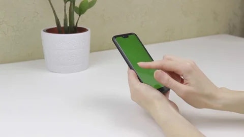 Female hands using a smartphone with green screen Stock Footage 127838033