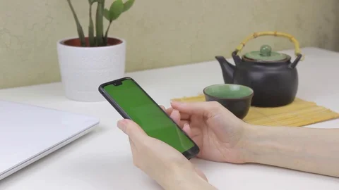 Female hands using a smartphone with green screen Stock Footage 127838044