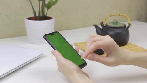 Female hands using a smartphone with green screen Stock Footage 127838065