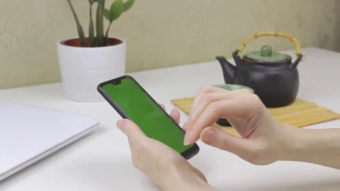 Female hands using a smartphone with green screen Stock Footage 127838108