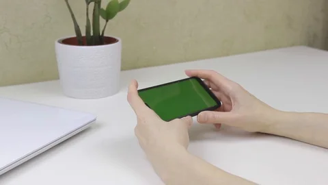 Female hands using a smartphone with green screen Stock Footage 127838169