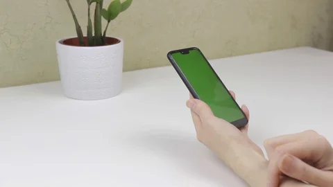 Female hands using a smartphone with green screen Stock Footage 127838281