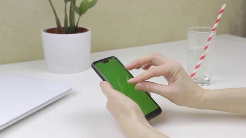 Female hands using a smartphone with green screen Stock Footage 127838309