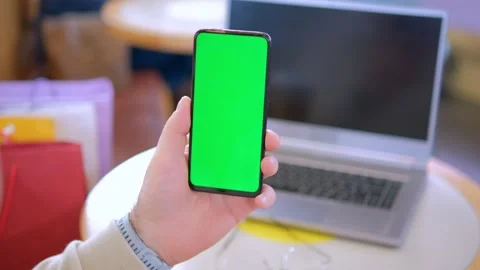 Female hands using smartphone mobile with empty green screen top view sunshine Stock-Footage 258654306