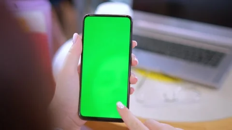 Female hands using smartphone mobile with empty green screen top view sunshine Stock Footage 263897656