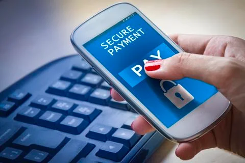 Female hands using a smartphone with secure payment on screen. Stock Photos