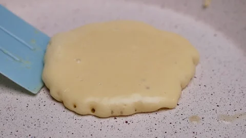 Female hands using a spatula to fliping over pancakes on a hot pan. Stock Footage 158661312