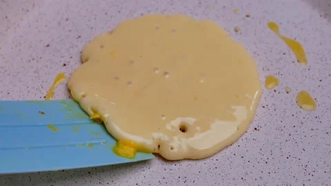 Female hands using a spatula to fliping over pancakes on a hot pan. 動画素材 158661549