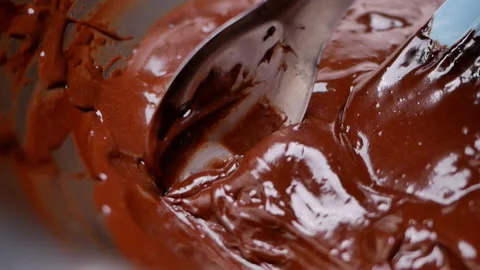 Female hands using a spoon to scoop chocolate batter onto tray prepare for bake. Stock Footage 158661112