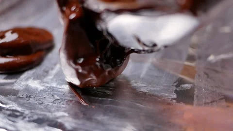 Female hands using a spoon to scoop chocolate batter onto tray prepare for bake. Stockbeeldmateriaal 158661116