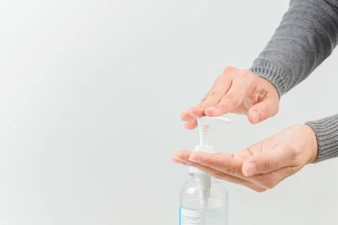 Female hands using washing hand with Alcohol Sanitizer isolate on a white bac Stock Photos
