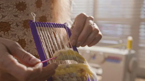 Female Hands Weaving Thick Woolen Yarn on Small Hand Loom for Craft Project Stock Footage 341945655