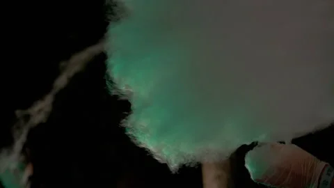 Female Hands Wind an Air Cloud of Cotton Candy from Sugar on a Wooden Stick. 4K Stock Footage 156418749