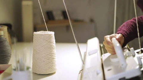 Female hands working on knitting machine at table in workshop Stock Footage 87379441