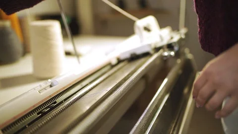 Female hands working on weaving machine in sewing workshop Stock Footage 87377015