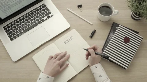 Female hands write to do list. Office or freelancer workspace overhead top view Stock Footage 83460993