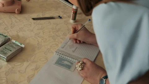 Female hands write in a notebook Stock Footage 129137362