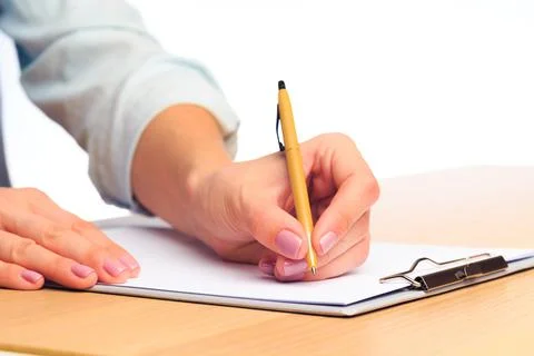 Female hands write in a notebook . Office place Stock Photos