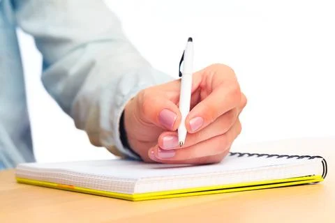 Female hands write in a notebook . Office place Stock Photos