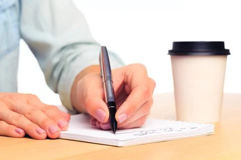 Female hands write in a notebook . Office place Stock Photos