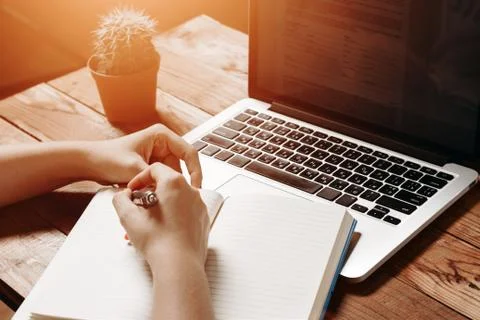 Female hands write to notebook Stock Photos