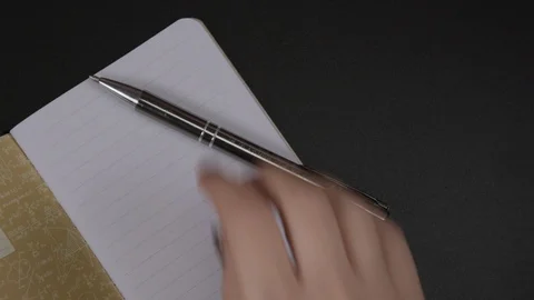 Female hands write with pencil To Do list 2020 on blank striped notebook Stock Footage 121800463