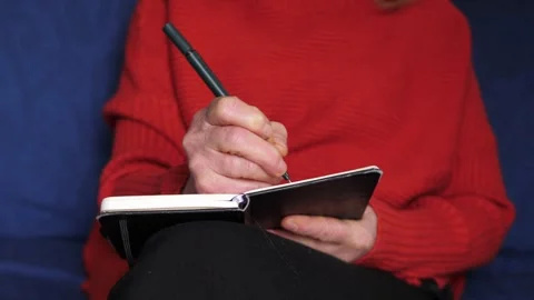 Female hands writing notes in black notebook during daily organization Stock-Footage 335699769