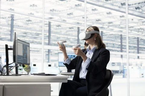 Female hardware developer using VR gear to design energy efficient Stock Photos