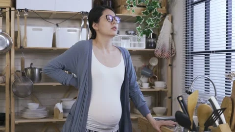 Female having backache is putting down her mug Stock Footage 151807651
