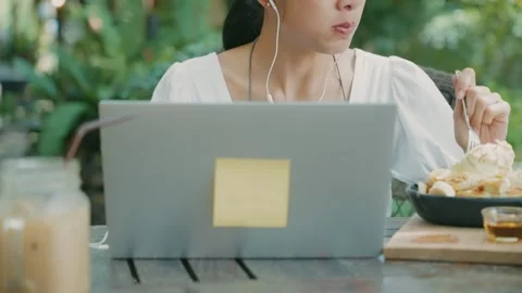 Female having desserts while working with laptop computer at the same time Video stock 270319715