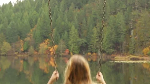 Female having a fun time on swing Stock Footage 72189903