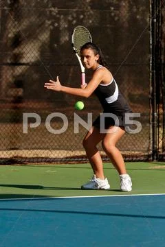 Female High School Tennis Player Prepares To Hit Forehand Stock Photos