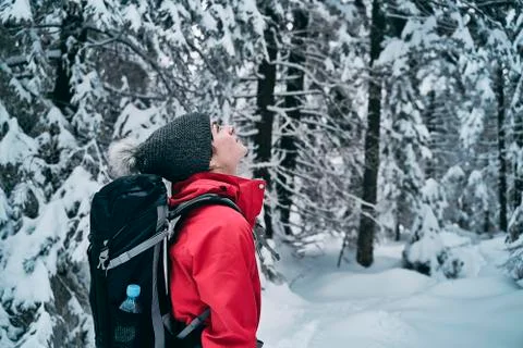 Female hiker admiring beautiful snowy nature. Stock Photos