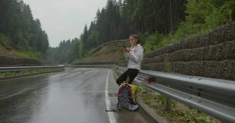 Female hiker using smartphone while standing outdoors Stock Footage 158729831