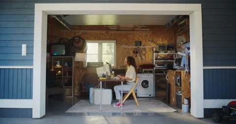 Female Hispanic Developer Using Computer In Retro Garage Stock Footage 255996766