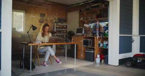 Female Hispanic Developer Using Computer In Retro Garage Stock Footage 255997053