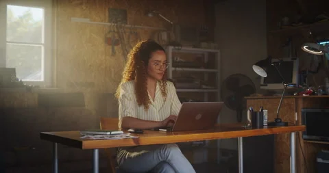 Female Hispanic Developer Using Computer In Retro Garage Stock Footage 255997141