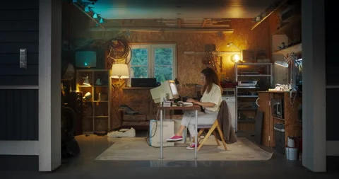 Female Hispanic Developer Using Computer In Retro Garage Stock Footage 255999740